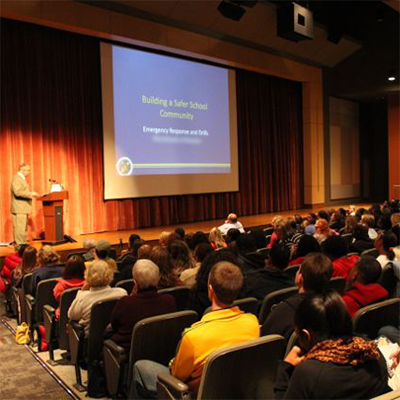 Human Intelligence Group instructor speaking to a group of teachers about school safety.